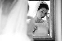 Bride looking herself in the mirror