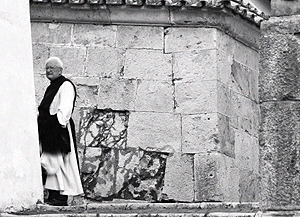 Italian monk going behind a wall