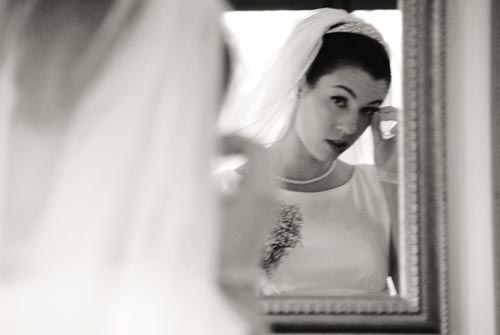 Bride looking herself in the mirror