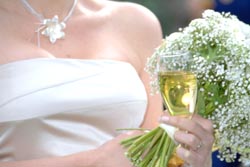 bride with a champagne glass and flowers