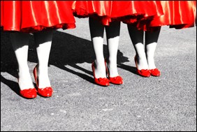 Three girls with red dresses and red shoes