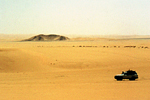 Sahara desert sand with 4x4 car driving