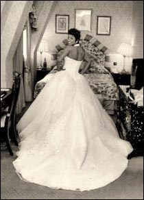 A large wedding dress being photographed from behind