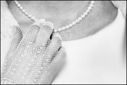 Vintage wedding dresses on abride touching her necklace