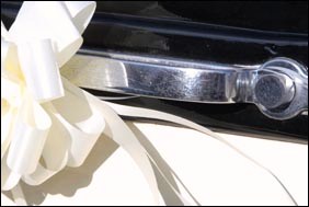 Example of wedding car decorations on the handle of an old Rolls Royce.