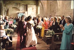Bride and groom walking up the isle in a church in Italy