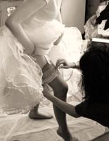 A bride being helped to get ready